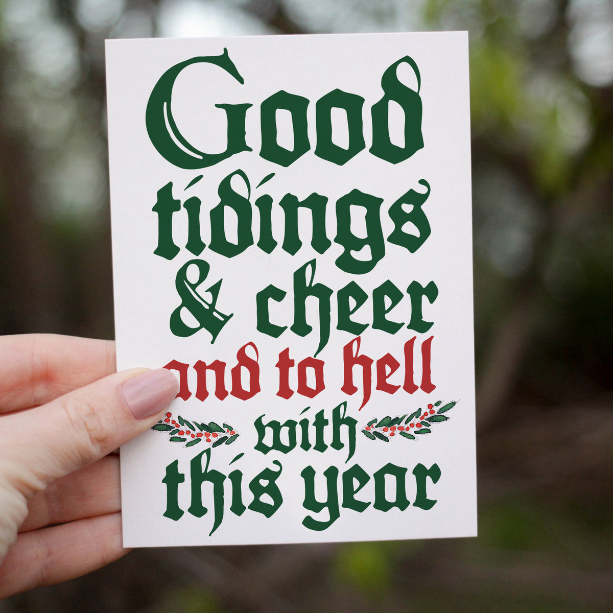 Holiday card set, one design, white background with centered blackletter text in dark green and red.