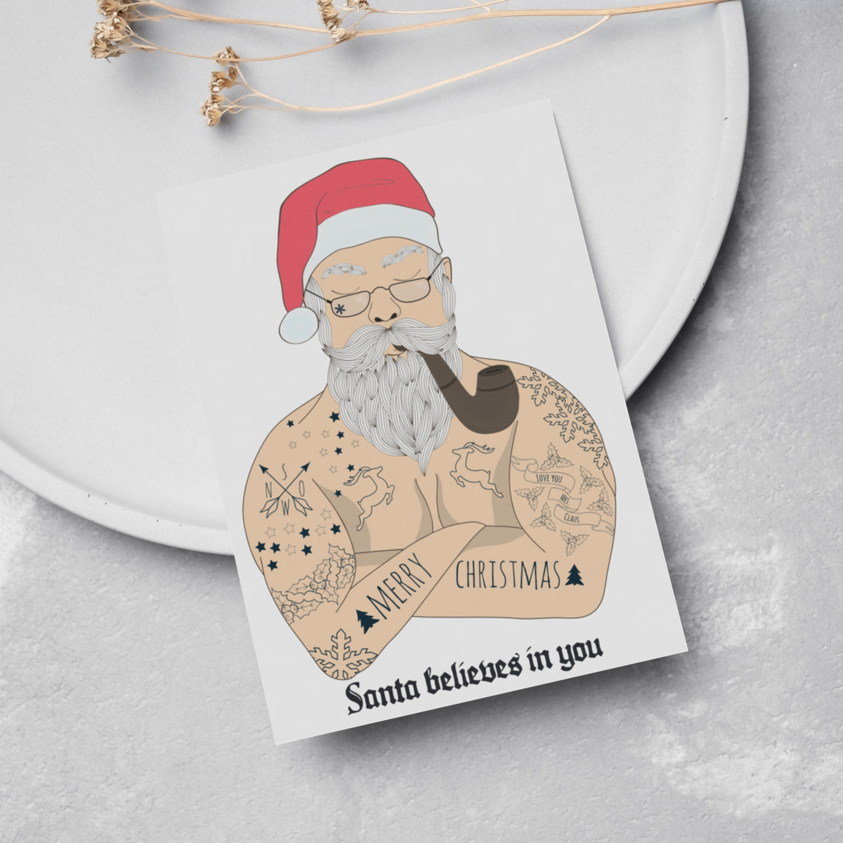 Card Christmas set, one design, illustrated figure with compass, snowflake, deer, and holly tattoos on chest and arms.