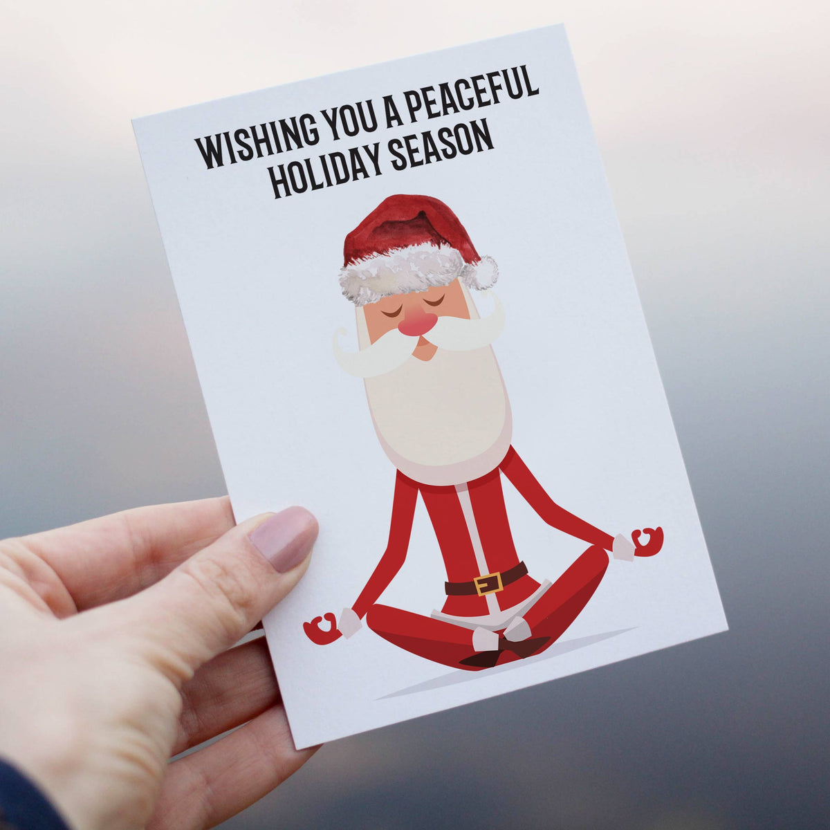 Holiday cards, one design, depicting a seated meditating Santa in a red suit with white trim and gold belt buckle.