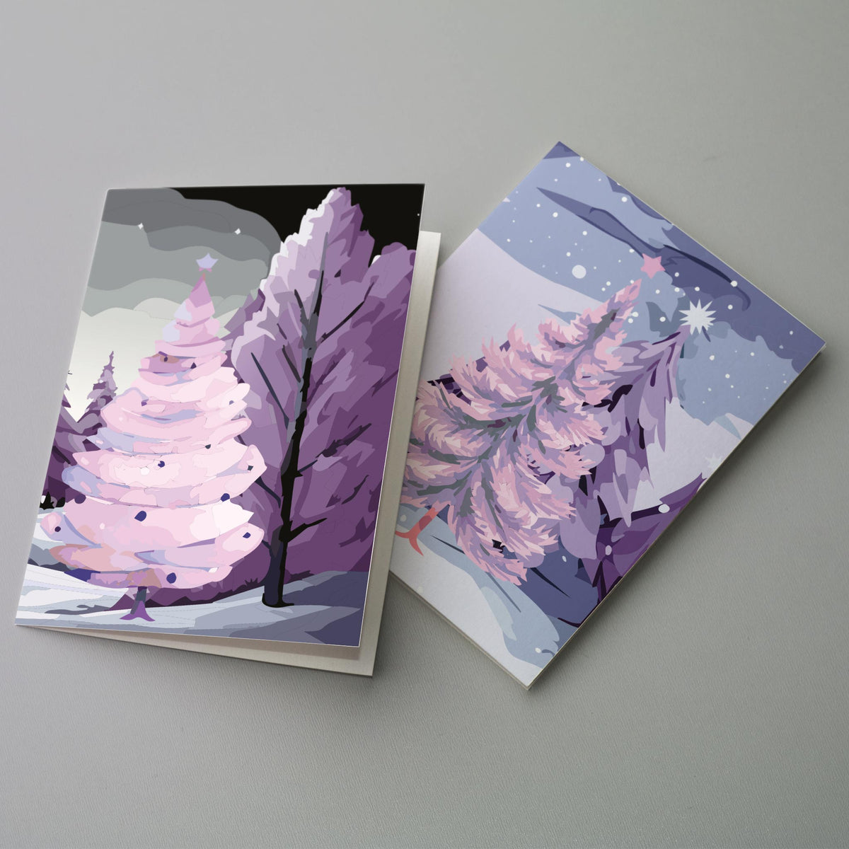 Pack of 24 Christmas cards with no printed text, illustrated in purple, pink, teal, and gray-blue.