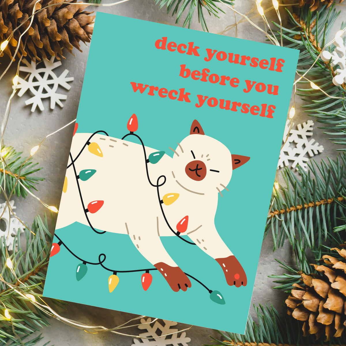 Christmas greeting cards in 12 designs with cats styled in reindeer antlers, jester hats, and scarves.