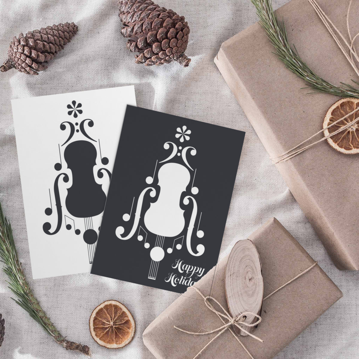 Holiday cards printed in black and white only, with a symmetrical musical graphic and script lettering reading "Happy Holiday