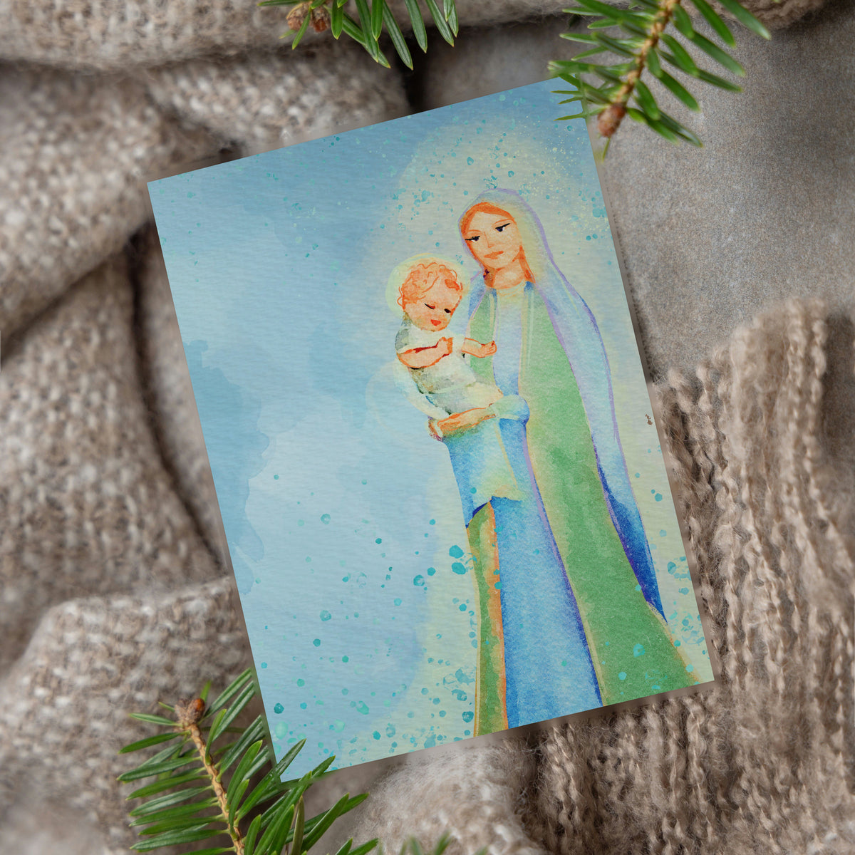 Christmas card collection with 12 watercolor designs including stable scenes, lanterns, and a snow-covered church.