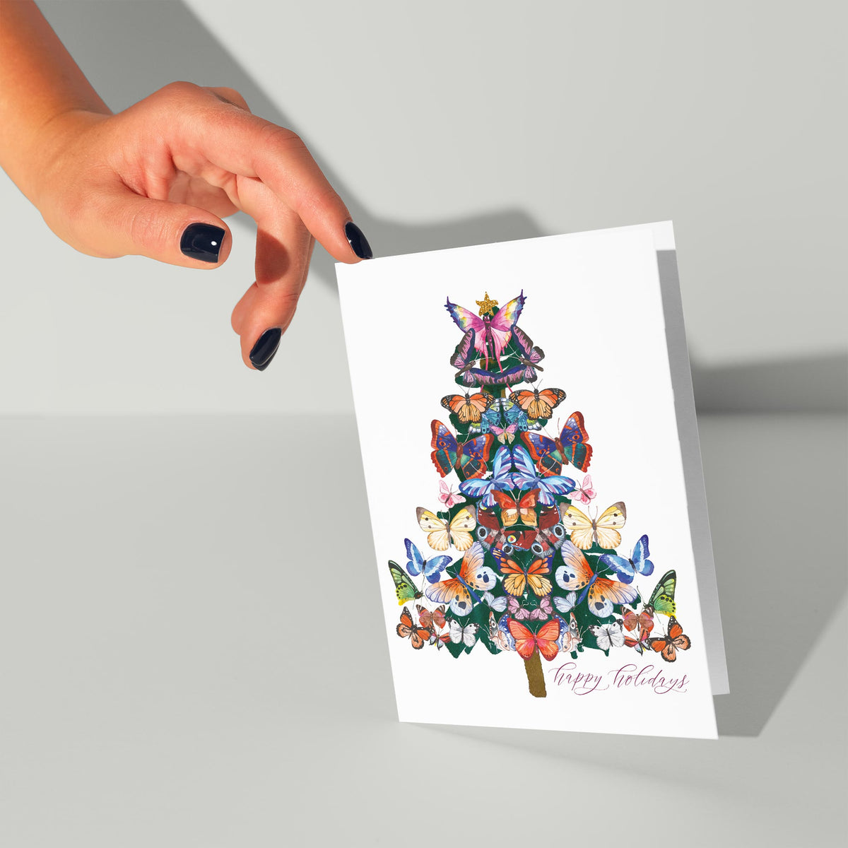 Card with a centered vertical butterfly tree illustration, fairy figure at top, and pink script text on white card stock.