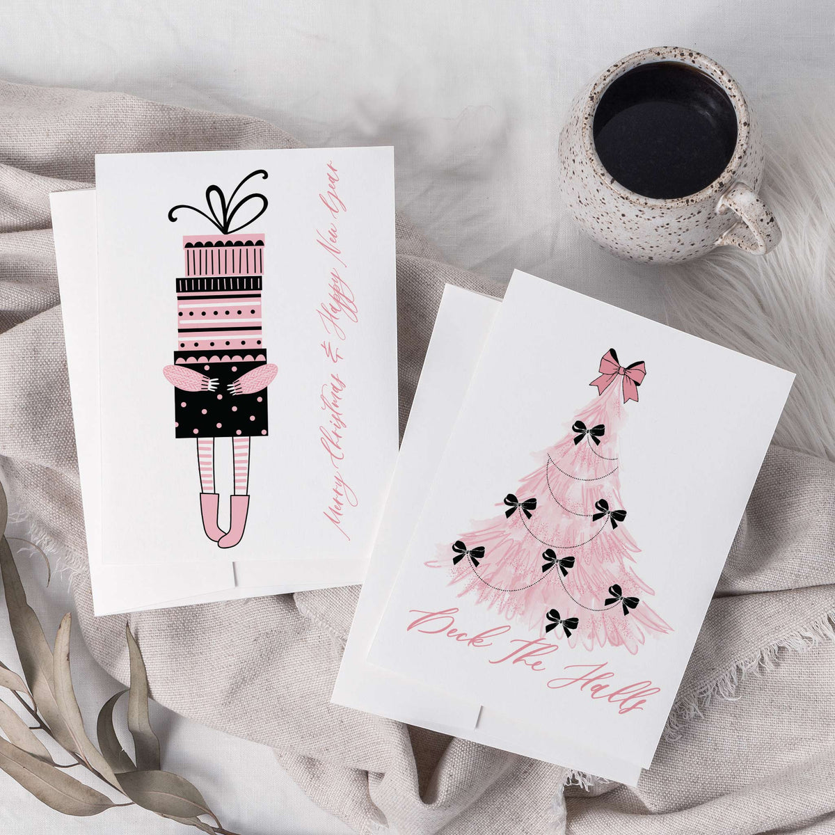 White holiday cards with single centred motifs in pink and black outline, six portrait and two landscape designs.