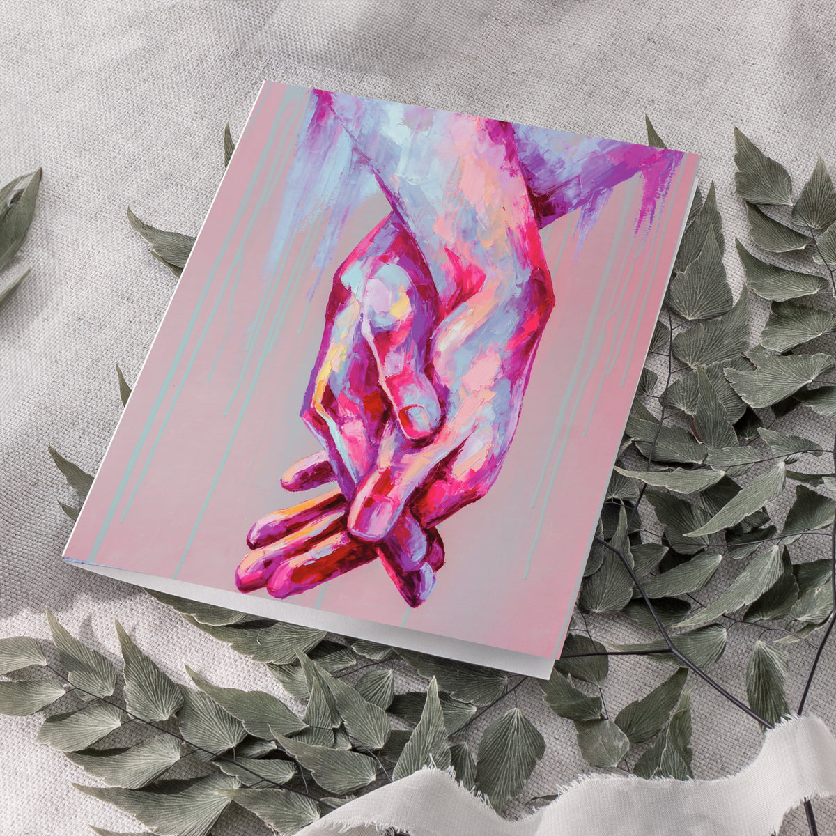 Brushstroke-style card design showing interlaced hands in magenta, lavender, and deep pink with teal and lavender drip streak