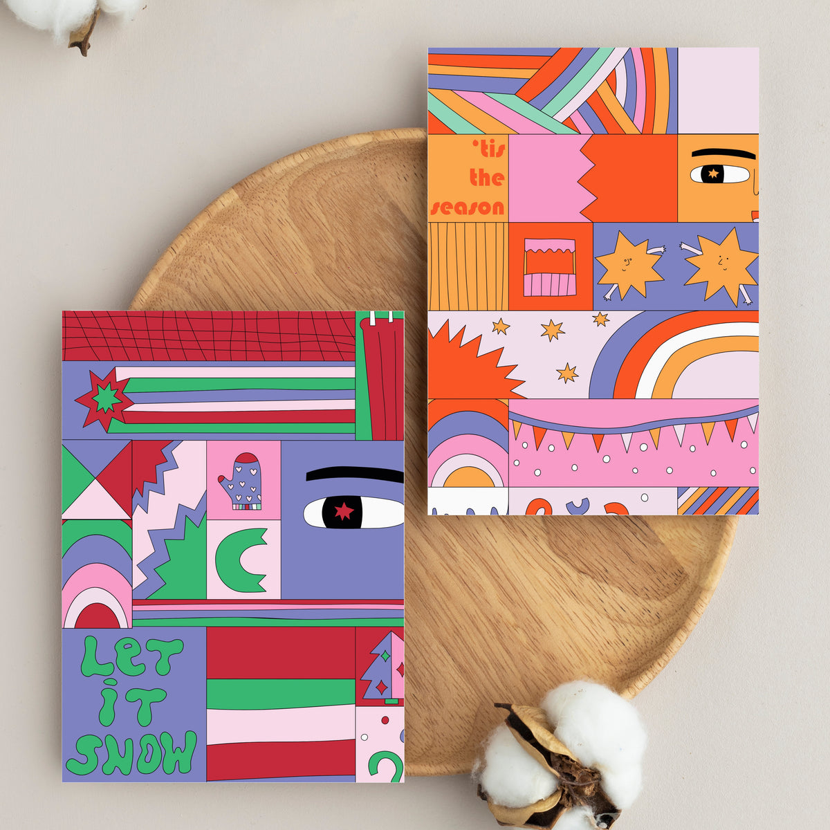 Folded holiday cards in four designs with bold mixed-case block lettering set within illustrated patchwork grids.