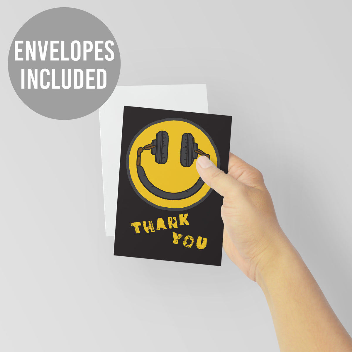 Thank you note cards in black with a yellow minimalist smiley face and black headphone illustration.