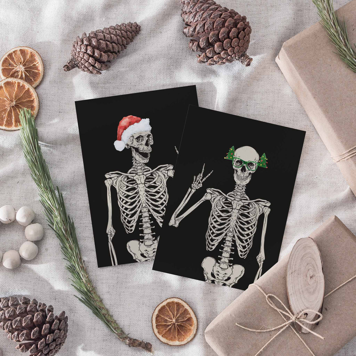 Four-design Christmas card pack, each with a black-and-white skeleton torso and skull on a black background.