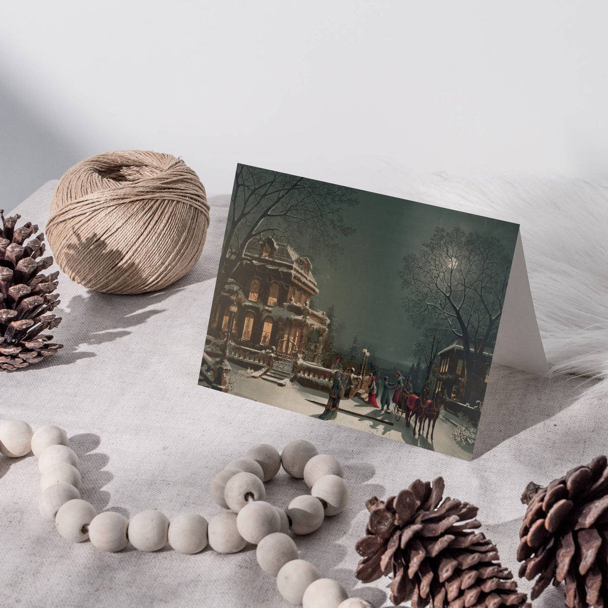 Christmas cards in landscape format with a chromolithograph-style scene of snow-covered houses at night.