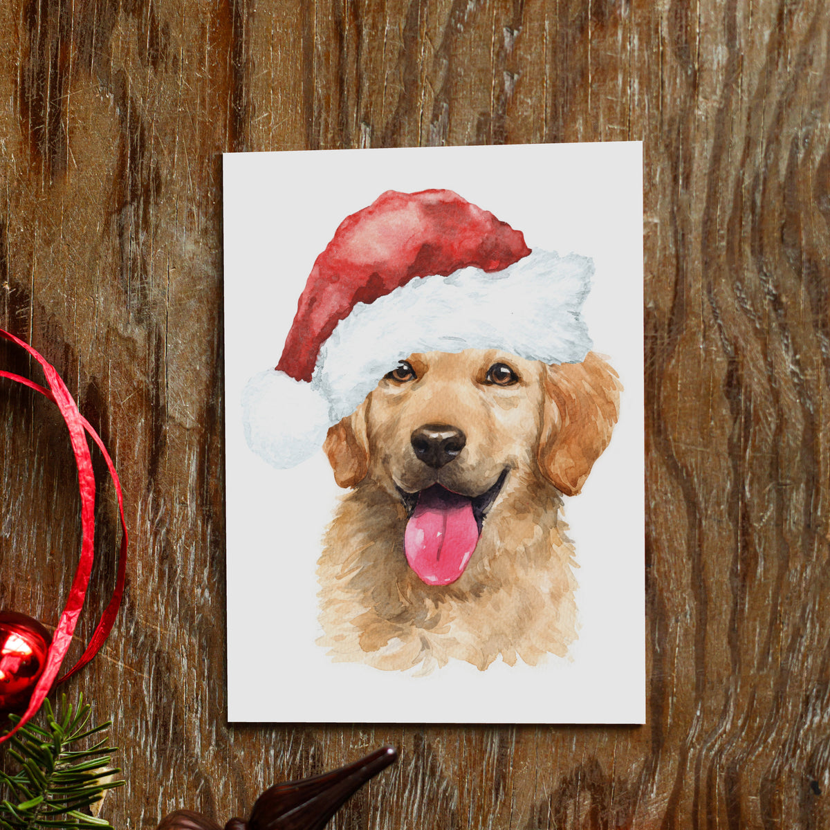 Loose watercolor illustration of a golden retriever in a red and white Santa hat, art fading softly into white ground.