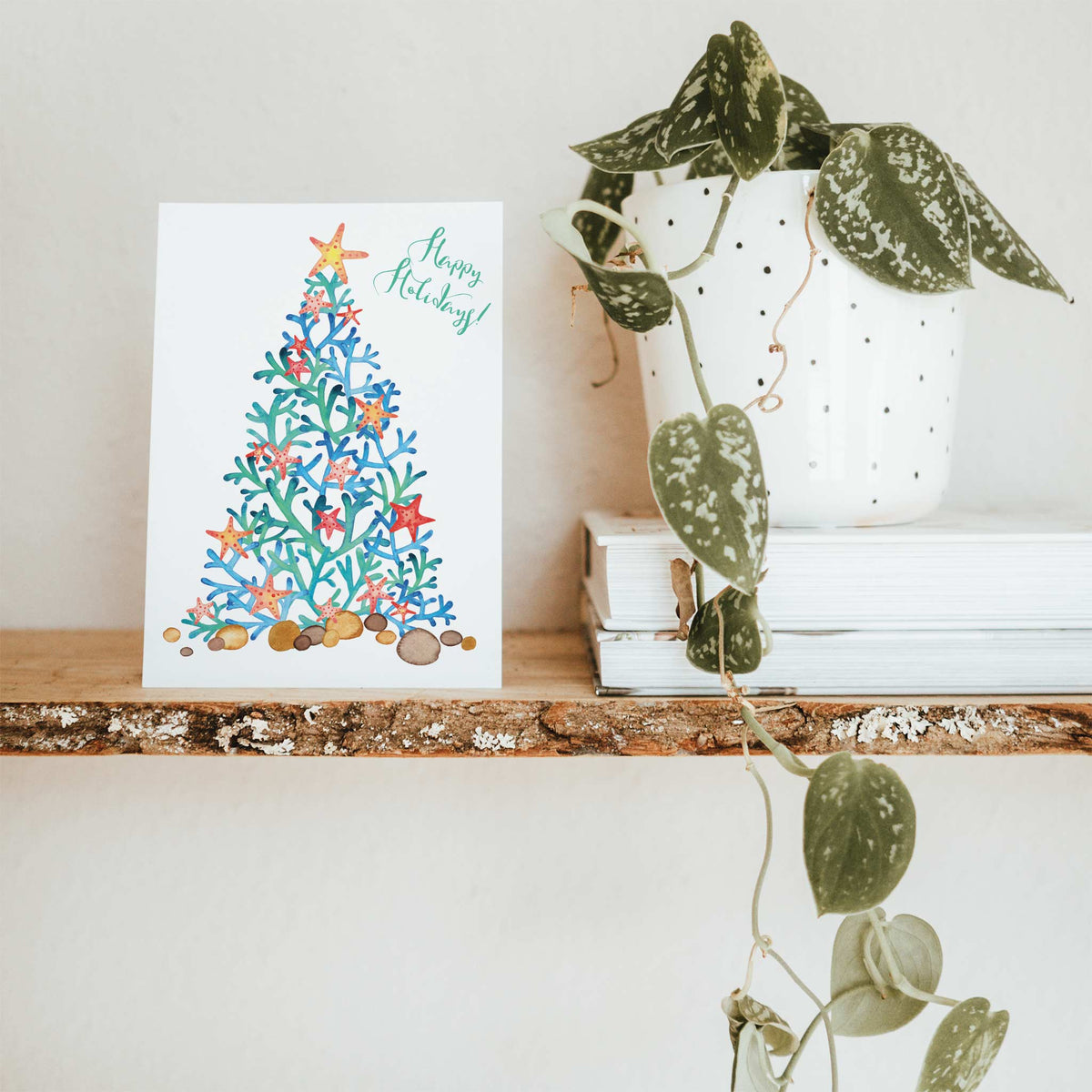 Beach holiday cards, two designs, casual script greeting in upper right corner, coral tree illustration at left.