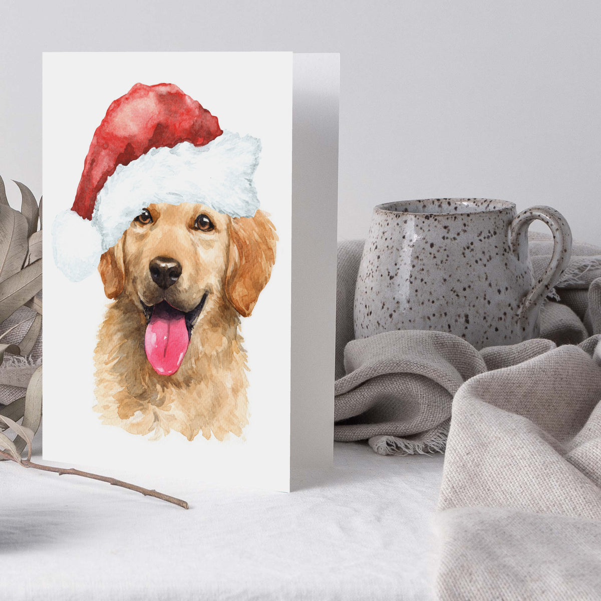 Matching holiday cards showing a golden retriever portrait cropped at the chest, wearing a red Santa hat.