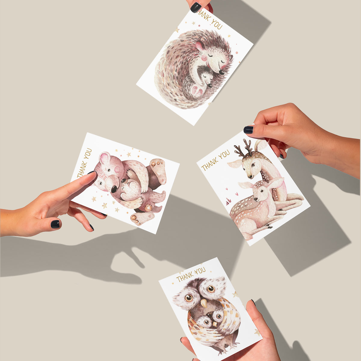 Parent-and-baby animal thank you cards with scattered gold star accents and hand-drawn style illustrations.