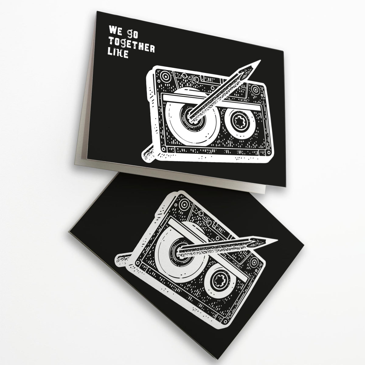 All-caps white distressed lettering and cassette tape illustration with threaded pencil on a full-bleed black card face.