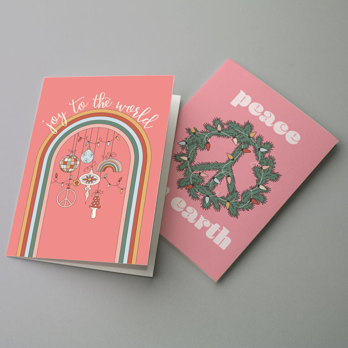 Set of 24 Christmas cards mixing line-art characters, watercolor animals, and lettering-only designs on pastel backgrounds.