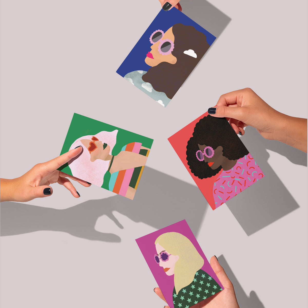 Cards in four designs showing side-profile portrait illustrations of women wearing statement sunglasses.