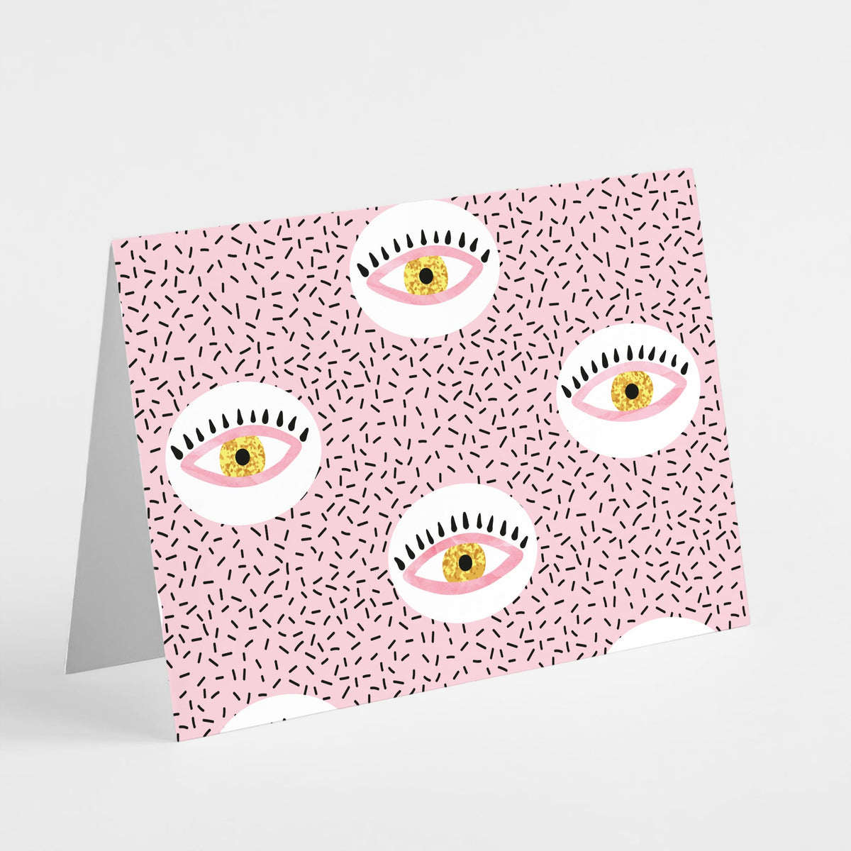 Pack of 24 illustrated notecards with stylized eye motifs on alternating patterned backgrounds.