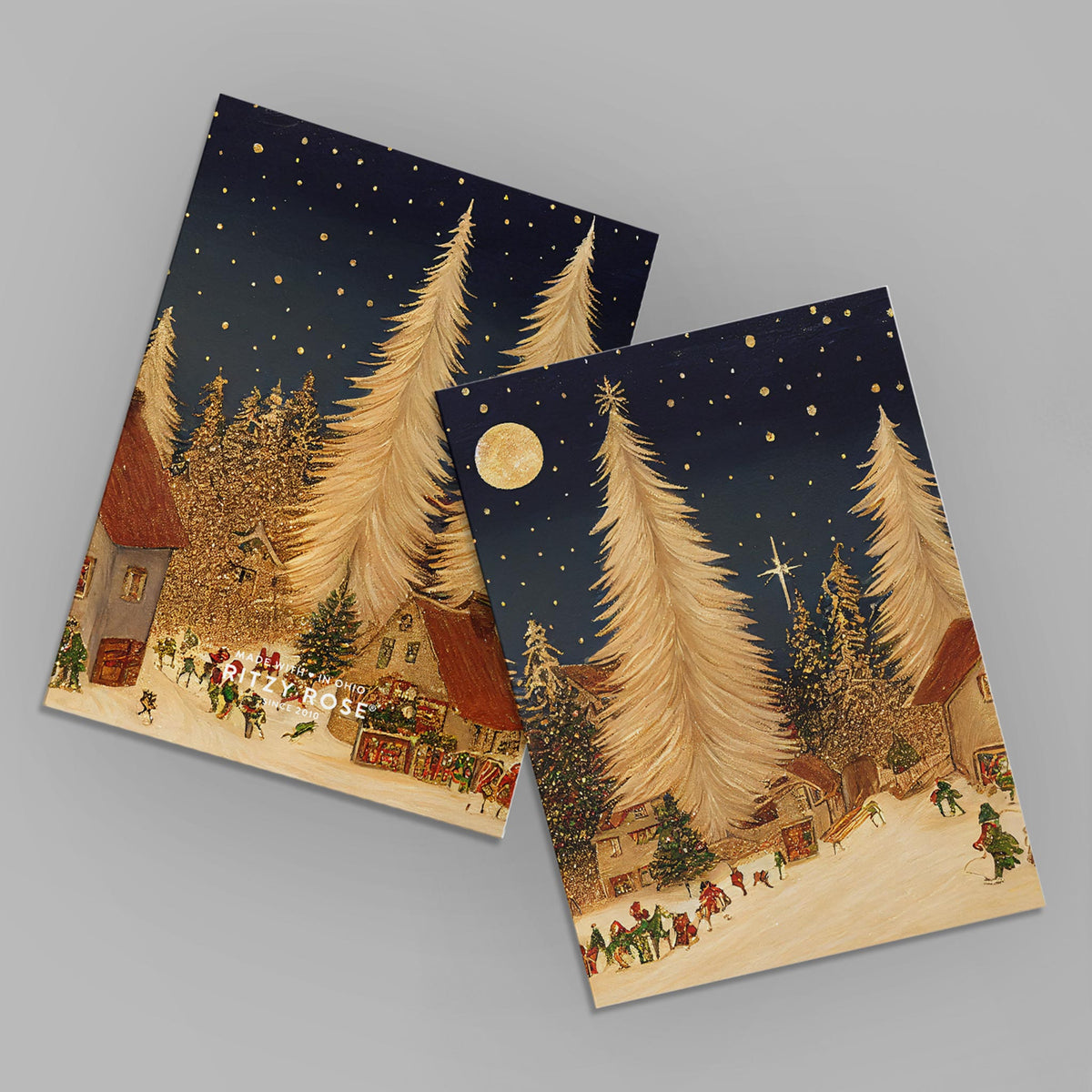 Set of 24 cards with gold evergreen trees, snowy villages, small figures, and navy night sky designs.