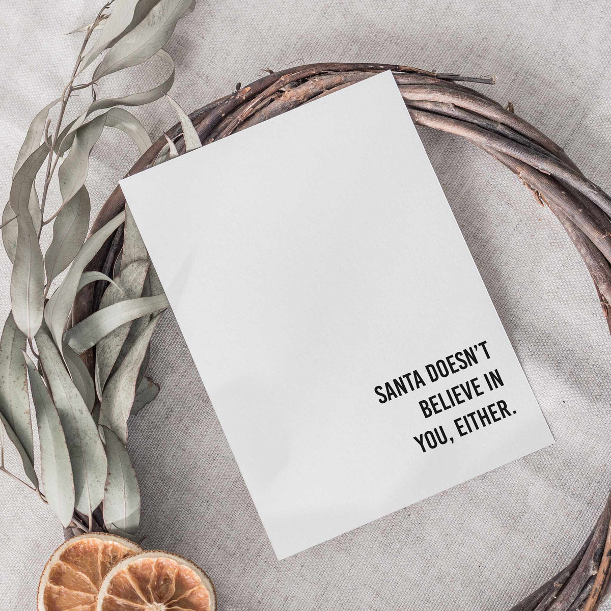 Bold black all-caps text on plain white folded cards, 12 sarcastic Christmas one-liners, 2 cards per design.