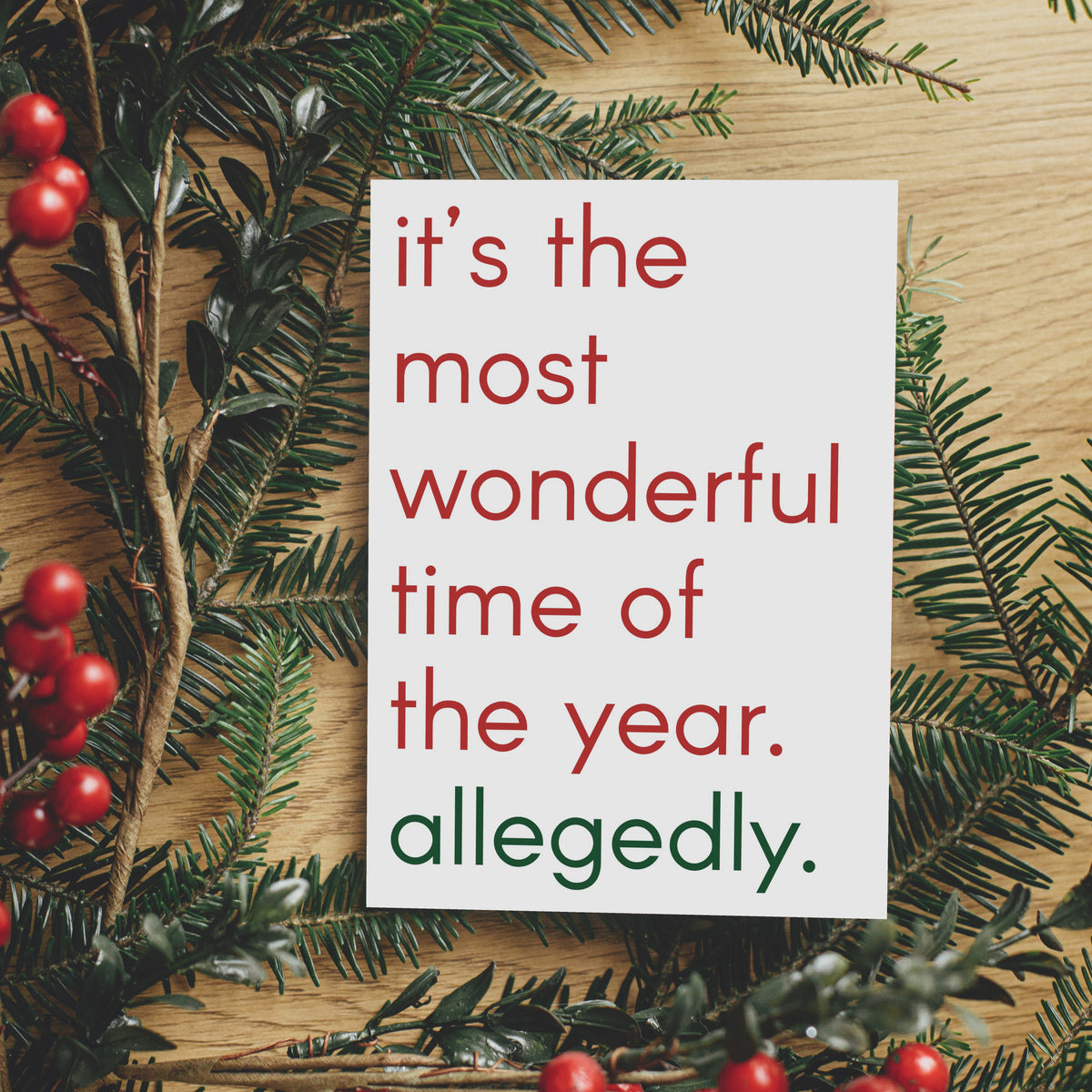 Holiday card reading "it's the most wonderful time of the year. allegedly." in lowercase red and green text.