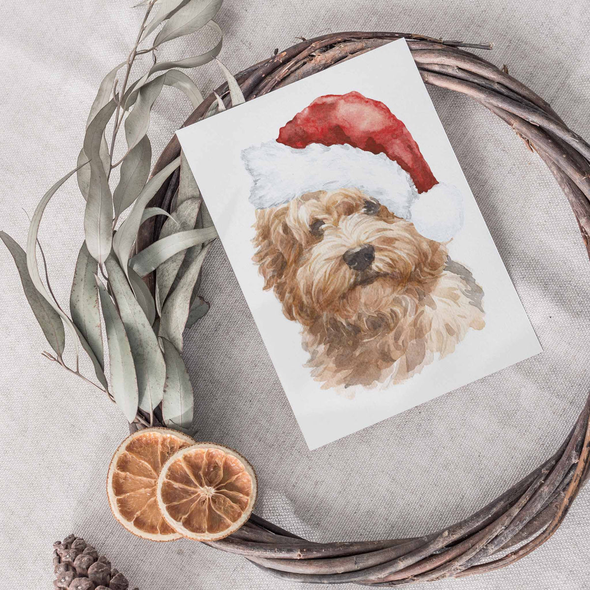 Labradoodle shown from shoulders up in watercolor style, red and white Santa hat, white card background, no text.