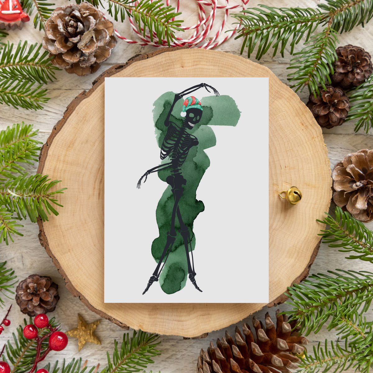 Greeting cards showing a full skeleton figure posed like a dancer against a watercolor color splash on a white background.
