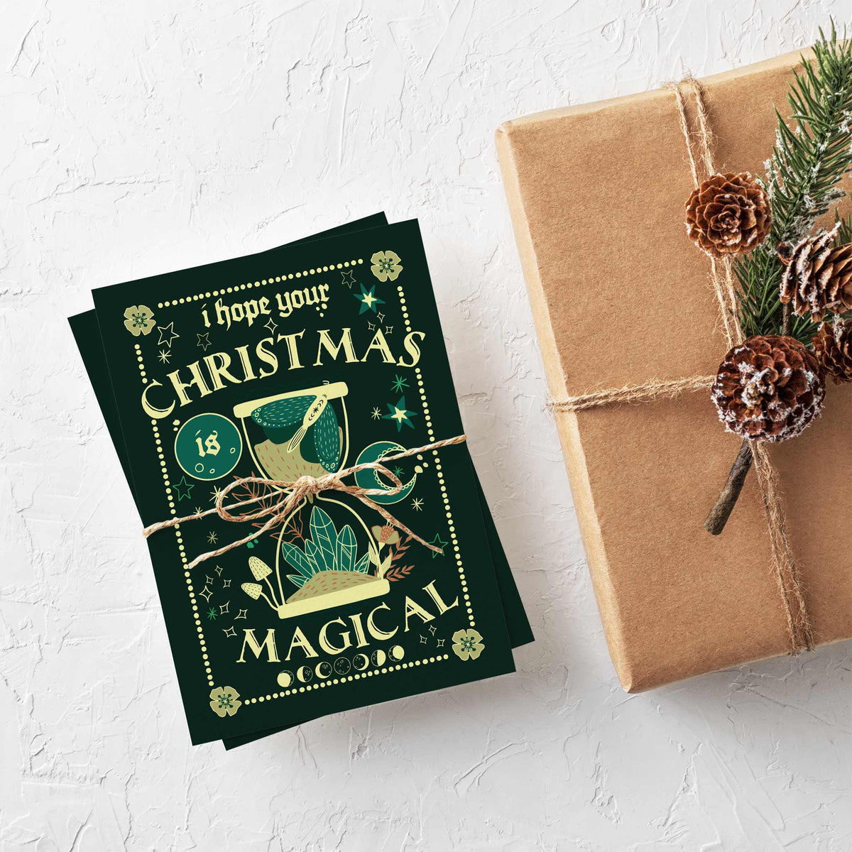 Dark green Christmas cards with dotted border frames, corner eye and flower motifs, and moon phase side borders.