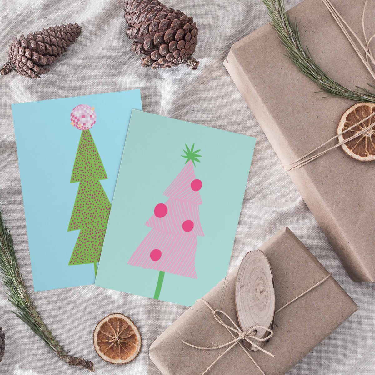 Holiday card set of 24 featuring disco ball and Christmas tree illustrations, four cards per design.