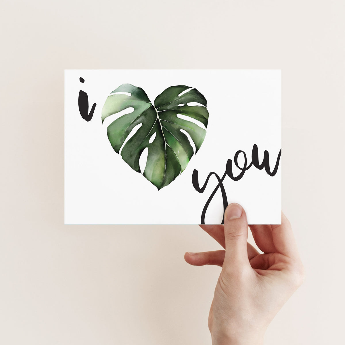 Flat white cards printed with a green heart-leaf botanical graphic and black script reading "i you."