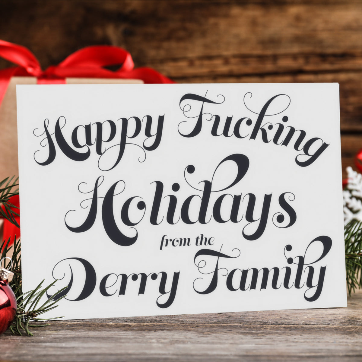 Personalized Christmas card set, black script on white, reading "Happy Fucking Holidays from the [Surname] Family."