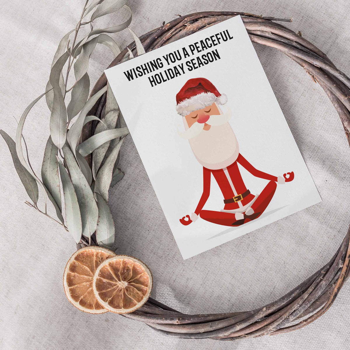 Holiday card set of 24 with centered black text above a cartoon Santa in a seated meditation pose.