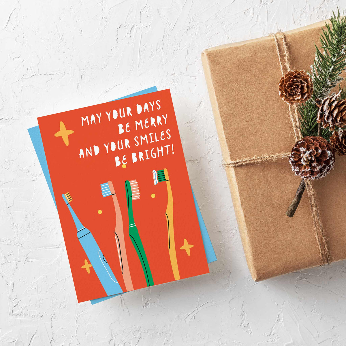 Flat-illustrated dental Christmas cards with yellow-orange sparkle details on solid color portrait-format backgrounds.