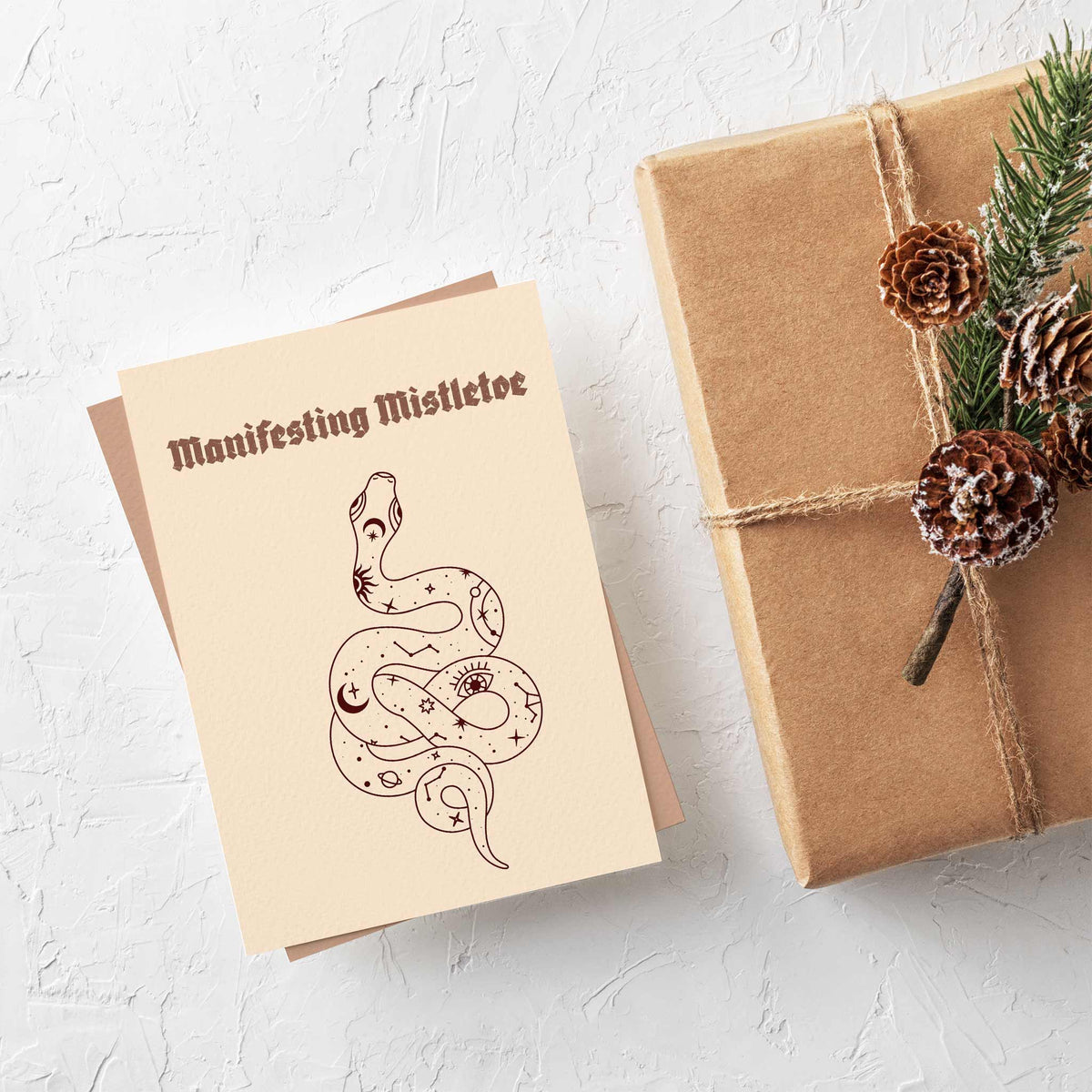 Set of 24 Christmas cards with four designs including "Sun and Sleighs Align" and "Manifesting Mistletoe" in mixed fonts.