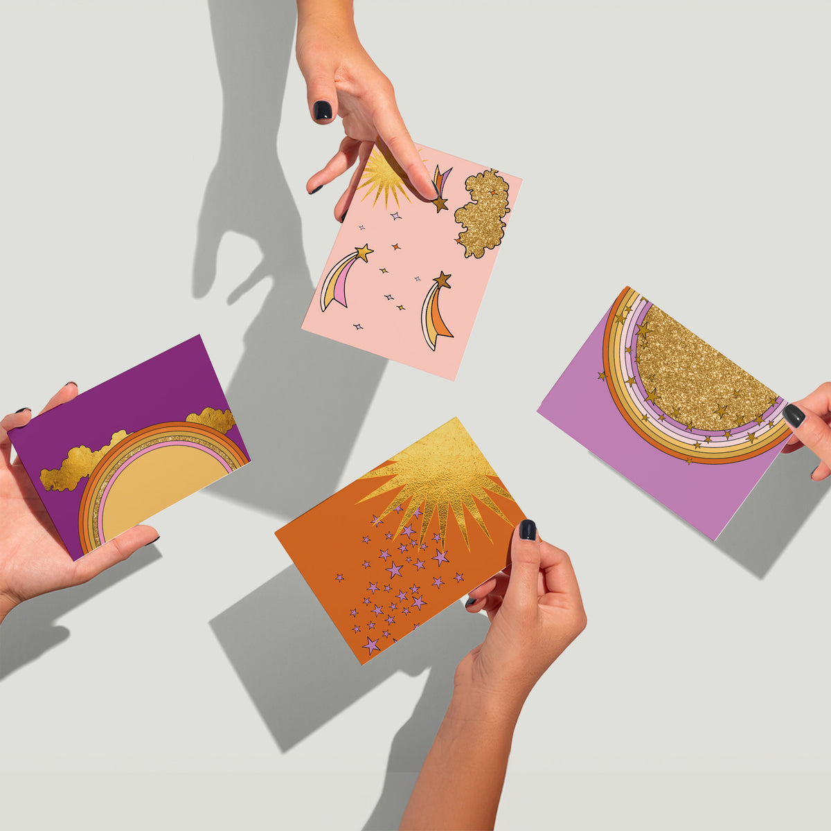 Blank notecards featuring layered celestial motifs including stars, clouds, and rainbows with gold-colored accents.
