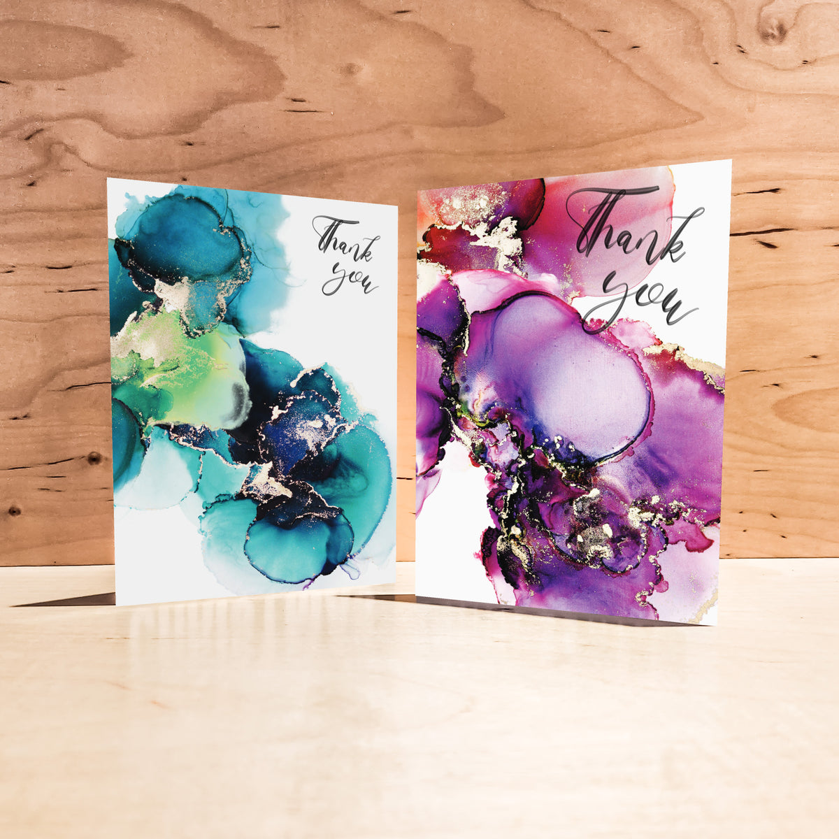 Four abstract Thank You card designs, each with white card stock negative space carrying black script text.