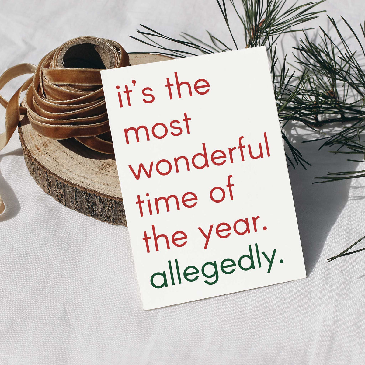 White Christmas cards, one design, with rounded lowercase sans-serif type in red fading to dark green.