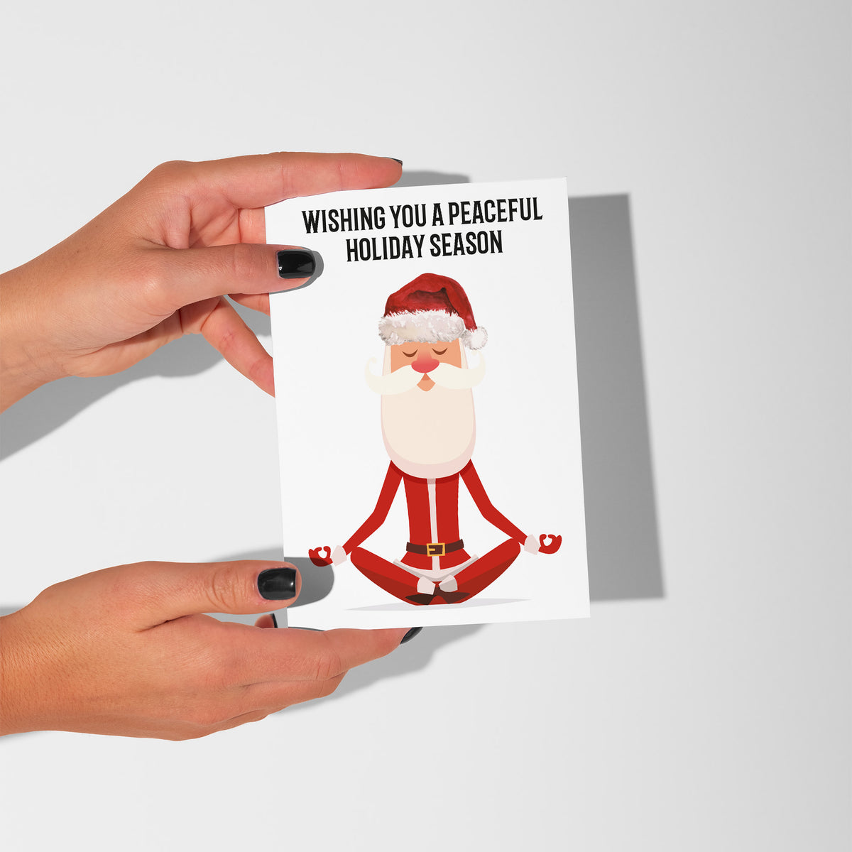 Pack of 24 white holiday cards printed with a meditating Santa Claus illustration and seasonal greeting.
