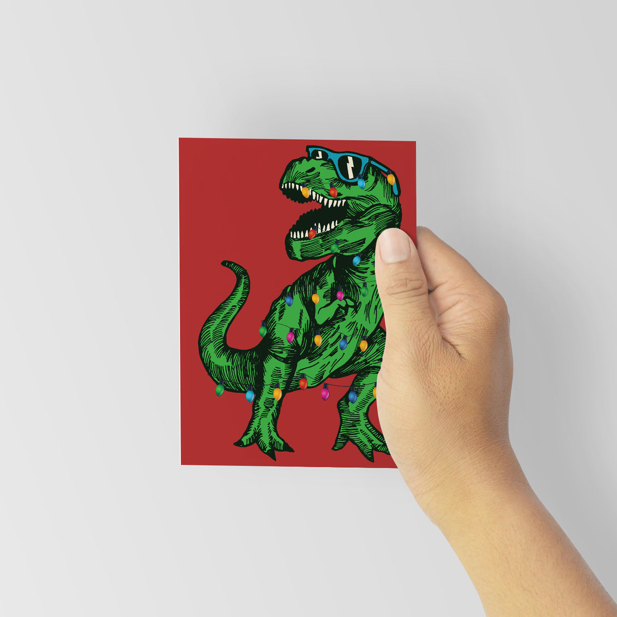 Portrait-format Christmas cards with a full-bleed background and a centered engraving-style T-Rex, set of 24.