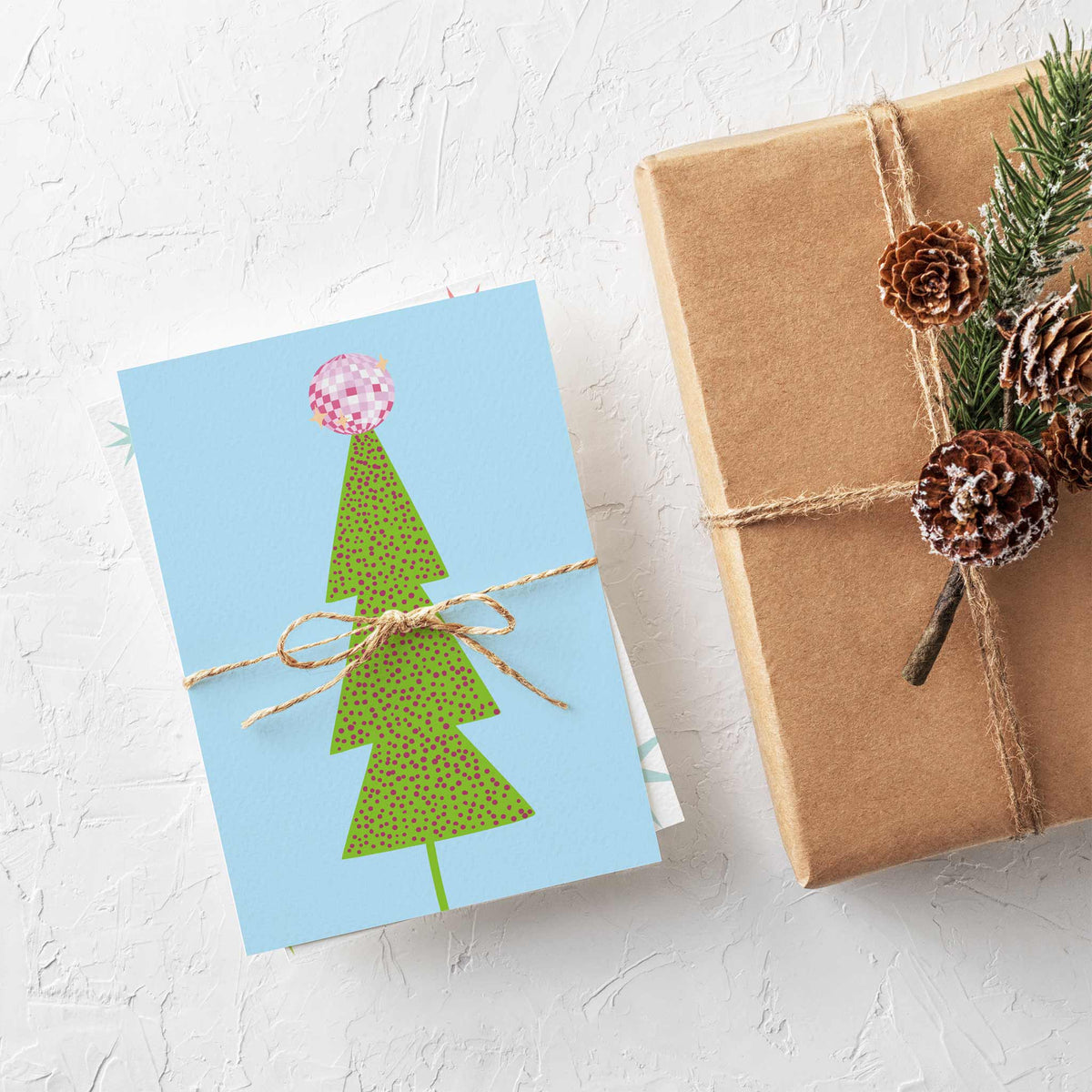 Boxed set of 24 Christmas cards with six disco ball and holiday tree designs in bright flat illustration.