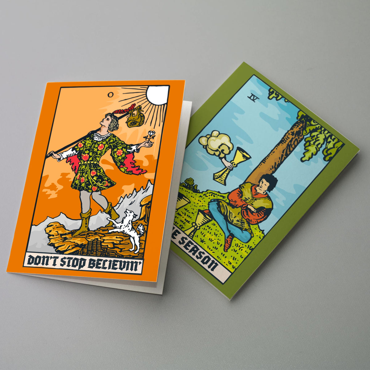 Holiday card set with illustrations based on the Four of Cups, Five of Cups, Knight of Cups, Fool, Tower, and Hanged Man.