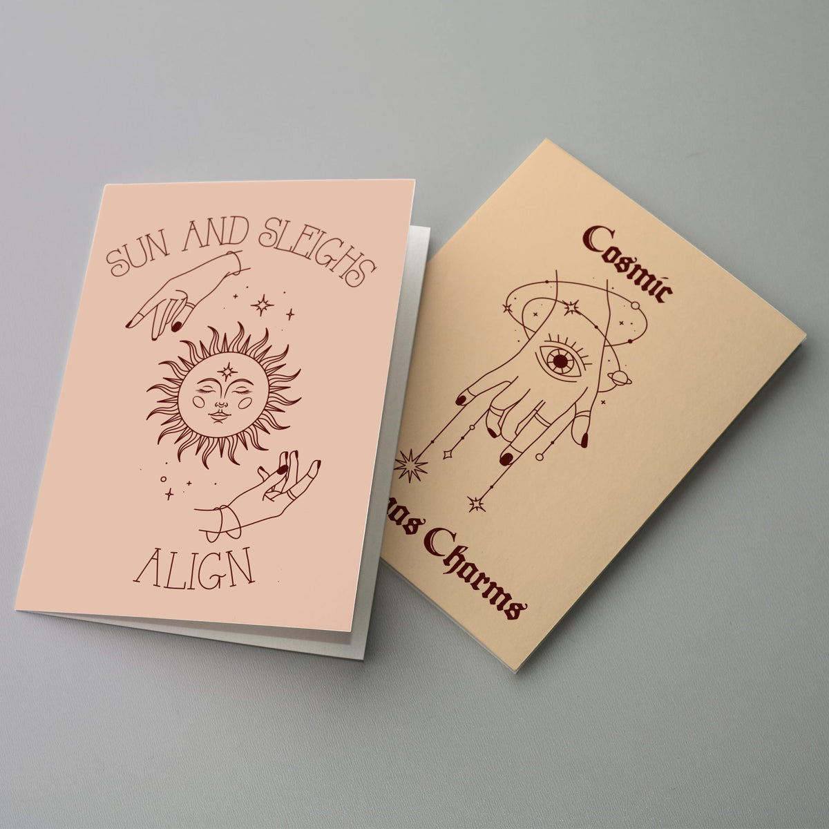 Holiday card set with minimalist hand-drawn illustrations of hands, stars, and celestial symbols in a monochrome linework sty