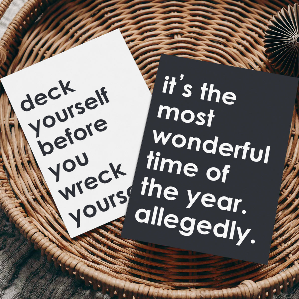 Black cardstock holiday card reading "it's the most wonderful time of the year. allegedly." in bold white block lettering.