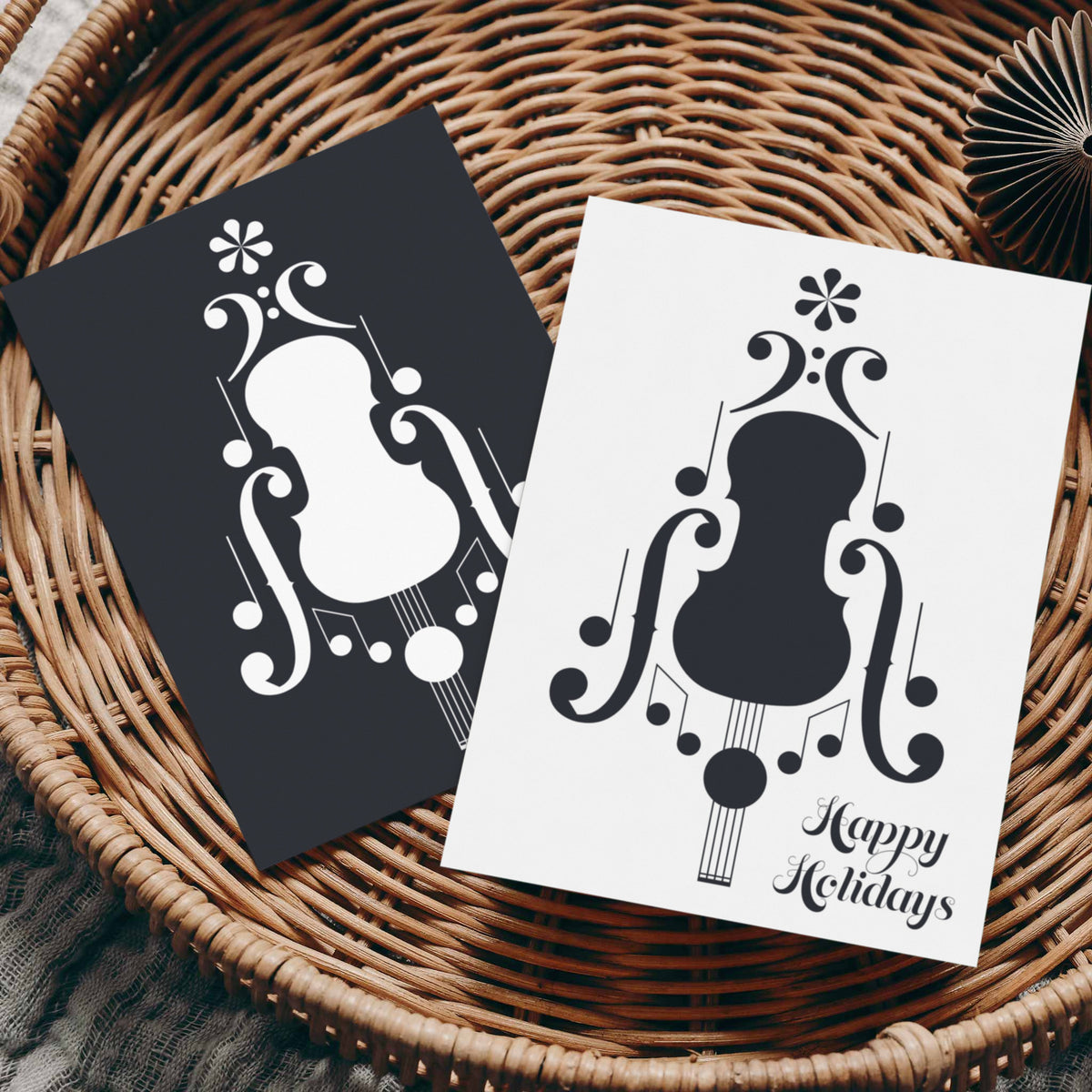 Portrait-format holiday cards featuring a centered music notation graphic on full-bleed black or white backgrounds.