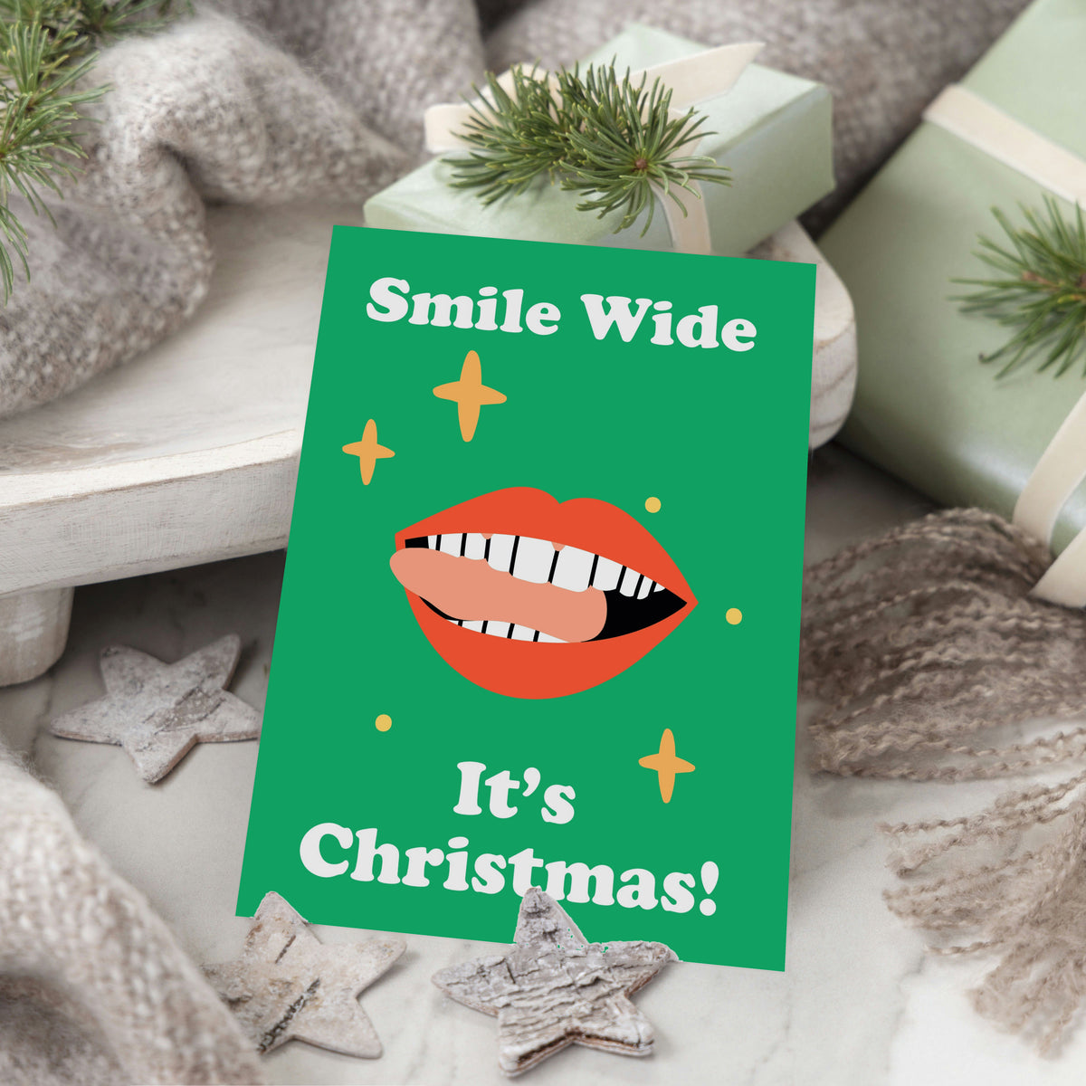 Christmas card pack of 24 with four dentist-themed designs in red-orange, peach, green, and light blue colorways.
