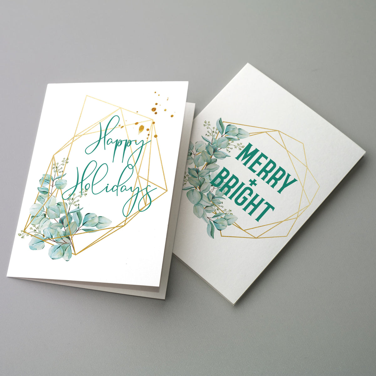 Holiday note cards featuring eucalyptus clusters, olive branch sprigs, and gold frame outlines in teal and green.