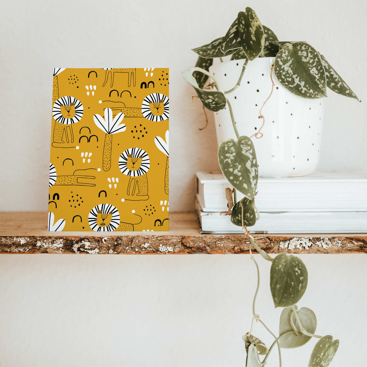Card set featuring black-and-white striped lion manes and palm frond motifs on a full-bleed mustard yellow ground.