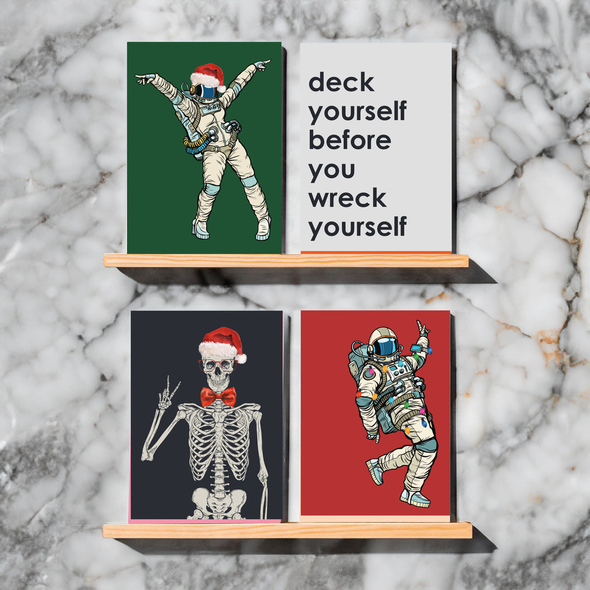 Holiday card collection including three gnomes arm in arm and skeletons in Santa hats.