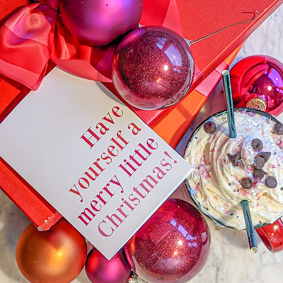 Christmas cards in a pink and coral palette with 12 novelty designs, sold as two cards per design.