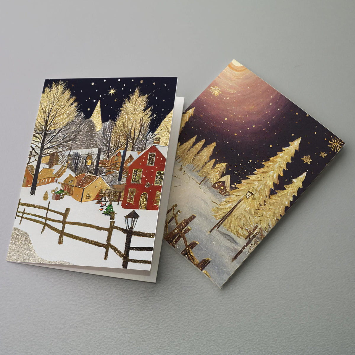 Holiday card set containing 24 cards across four gold and navy snowy village and forest illustrations.